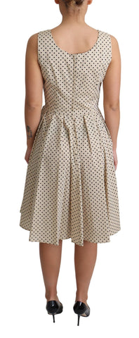 Beige polka dotted cotton A-line dress by Dolce & Gabbana, featuring a flattering fit and classic pattern.
