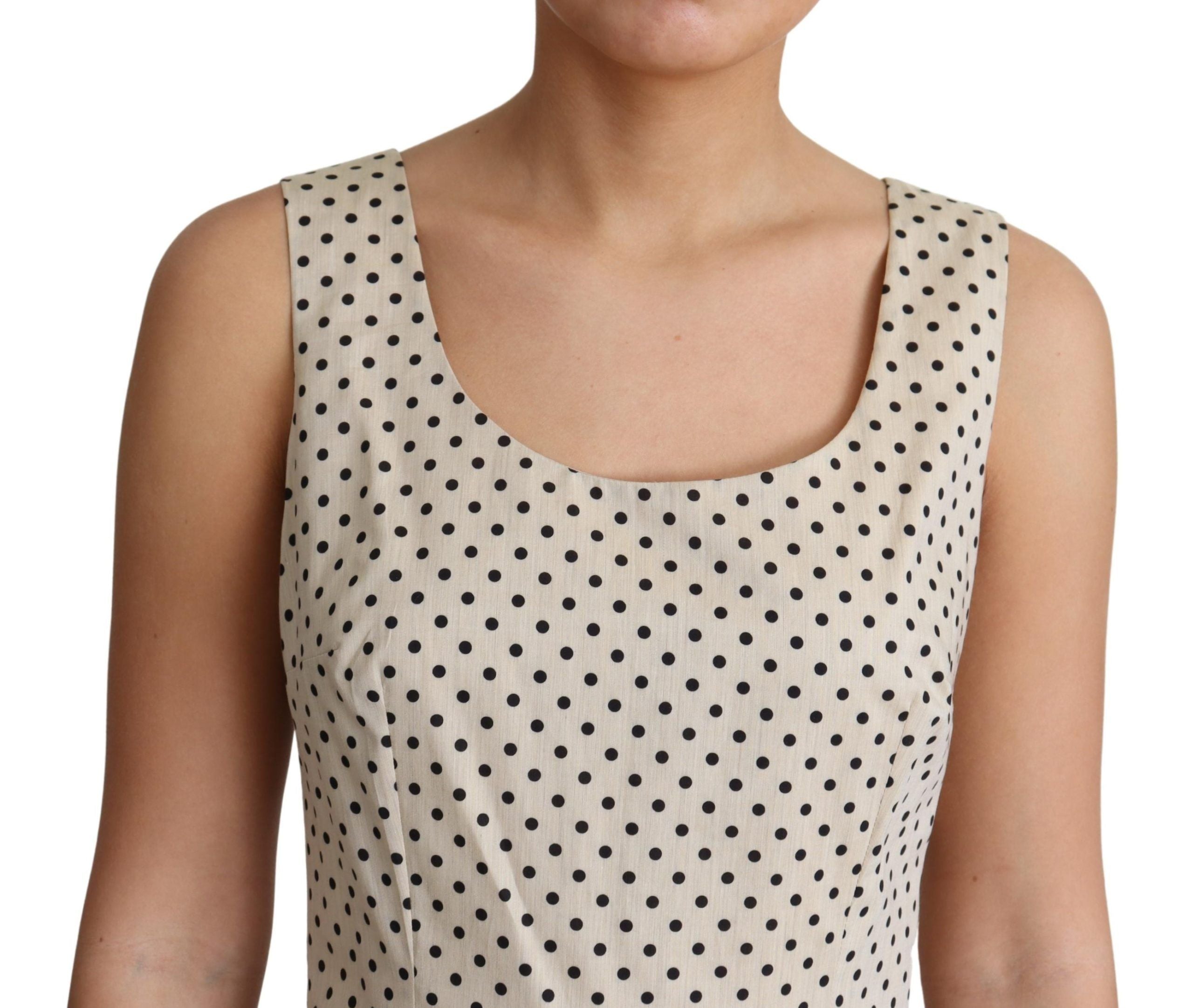 Beige cotton A-line dress with black polka dots by Dolce & Gabbana, featuring a classic, flowing silhouette and round neckline.