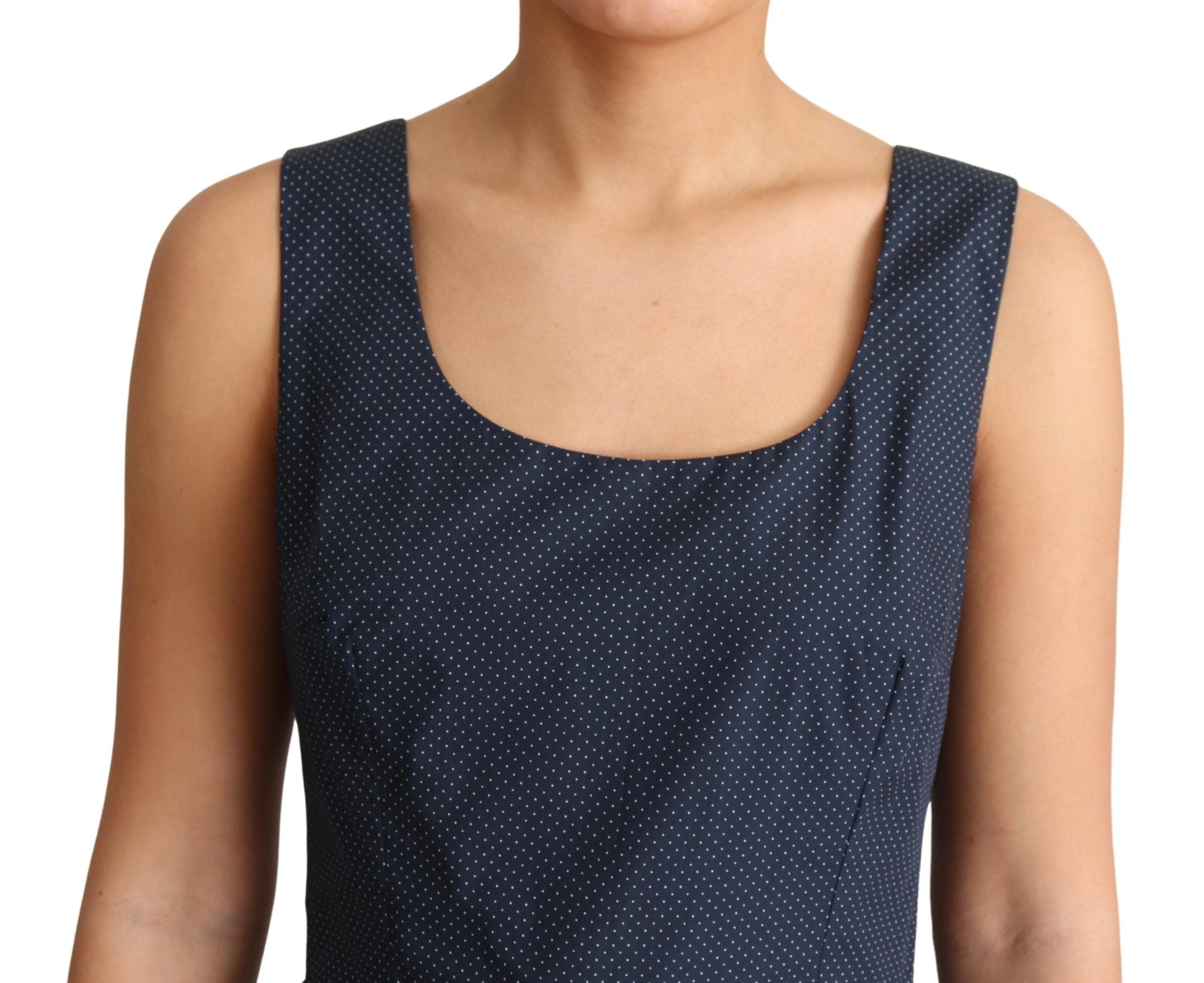 Blue polka dotted cotton A-line dress by Dolce & Gabbana with a fitted bodice and flared skirt, displayed on a hanger.