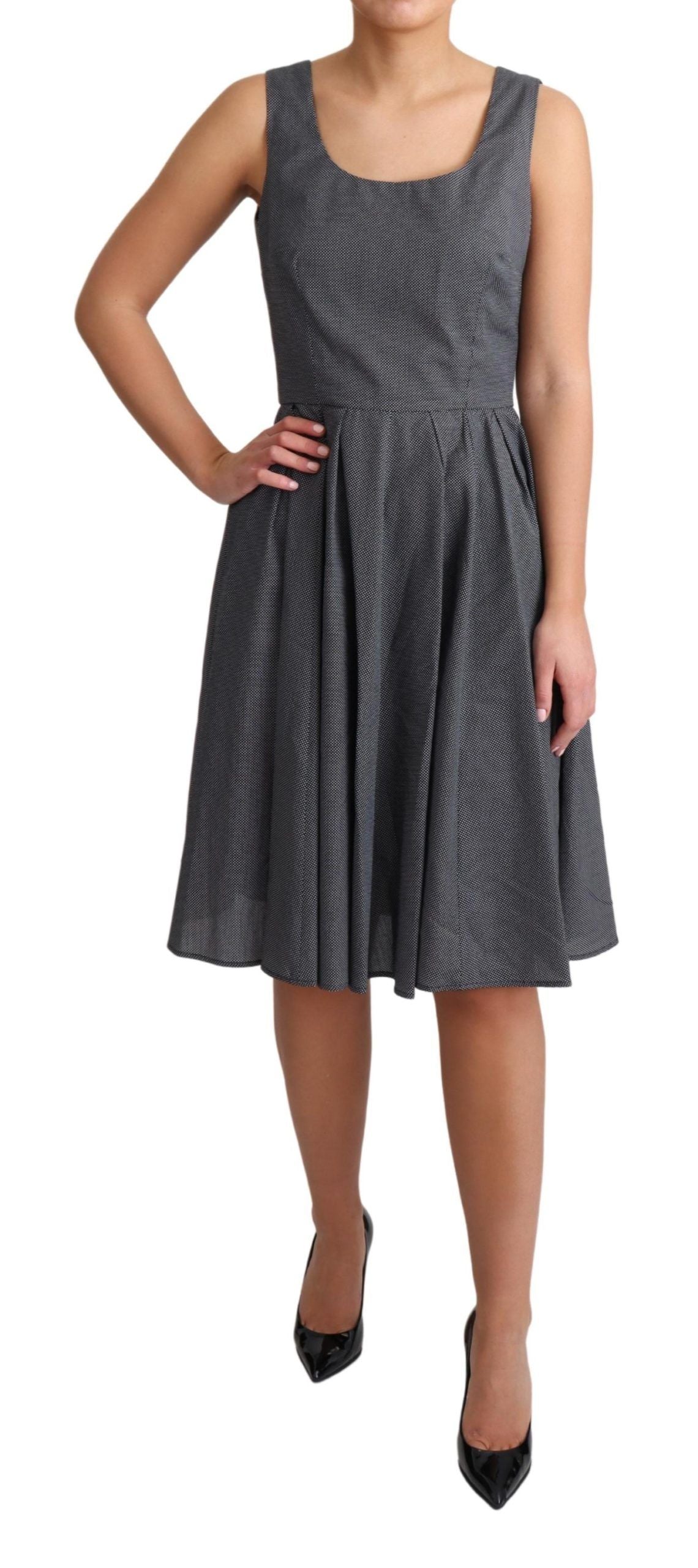 Black polka dotted cotton A-line dress by Dolce & Gabbana, featuring a classic fit and playful pattern.
