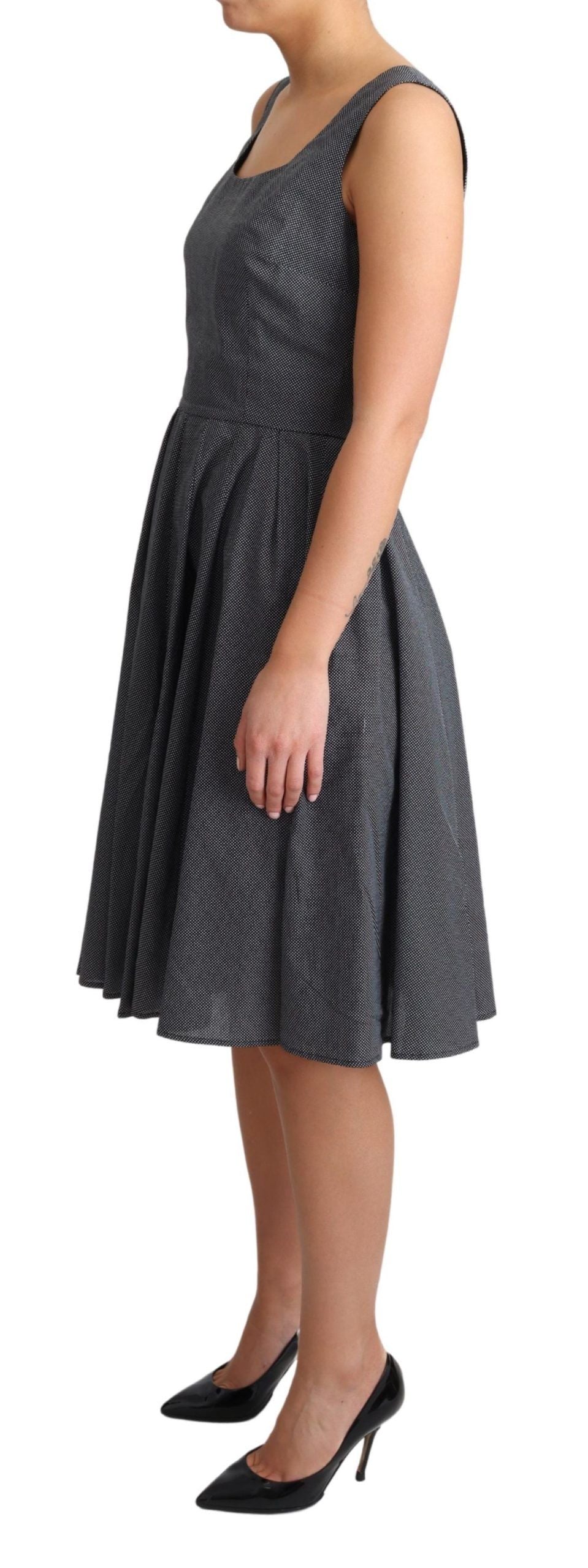 Black polka dotted cotton A-line dress by Dolce & Gabbana, showcasing a fitted waist and classic flared skirt.