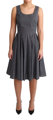 Black polka dotted cotton A-line dress by Dolce & Gabbana, featuring a fitted bodice and flowing skirt.