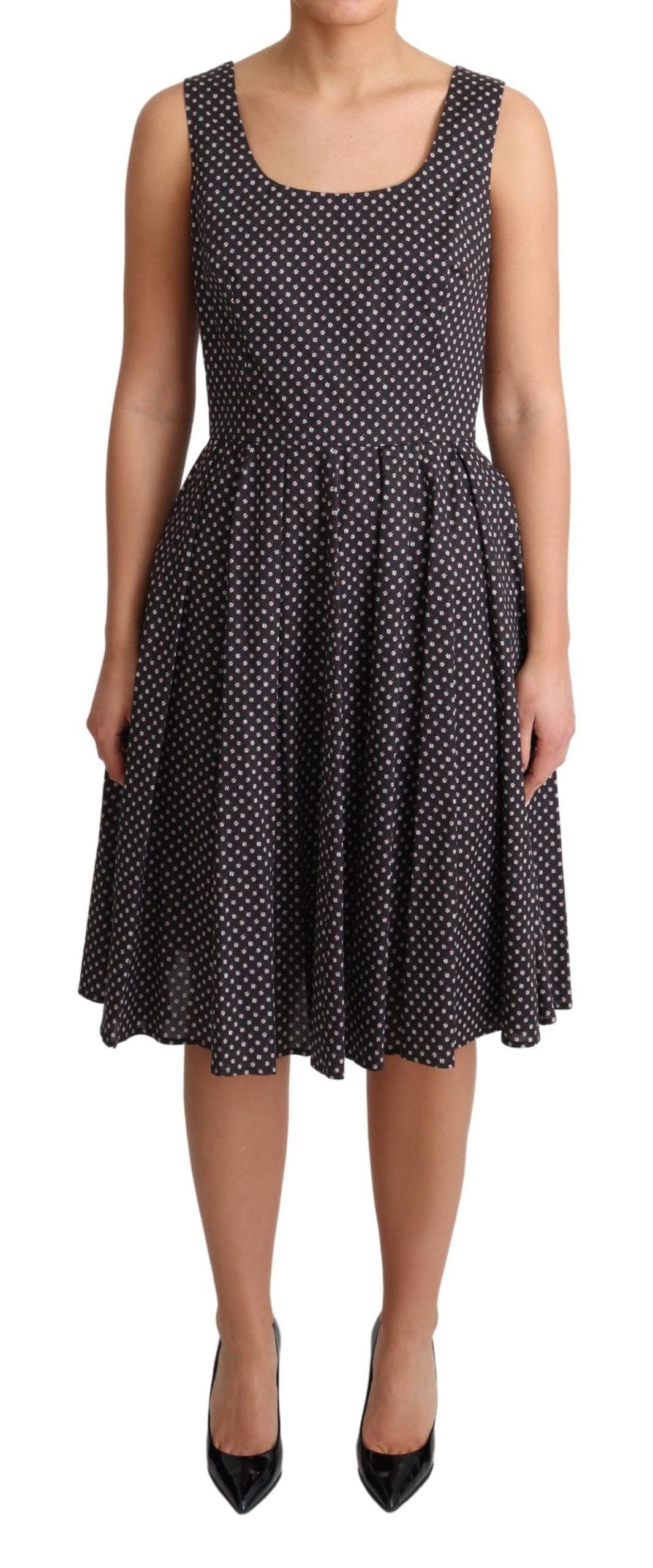 Black floral cotton A-line stretch dress by Dolce & Gabbana, featuring a fitted waist and vibrant floral pattern.