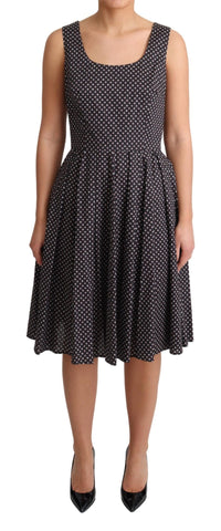 Black floral cotton A-line stretch dress by Dolce & Gabbana, featuring a fitted waist and vibrant floral pattern.