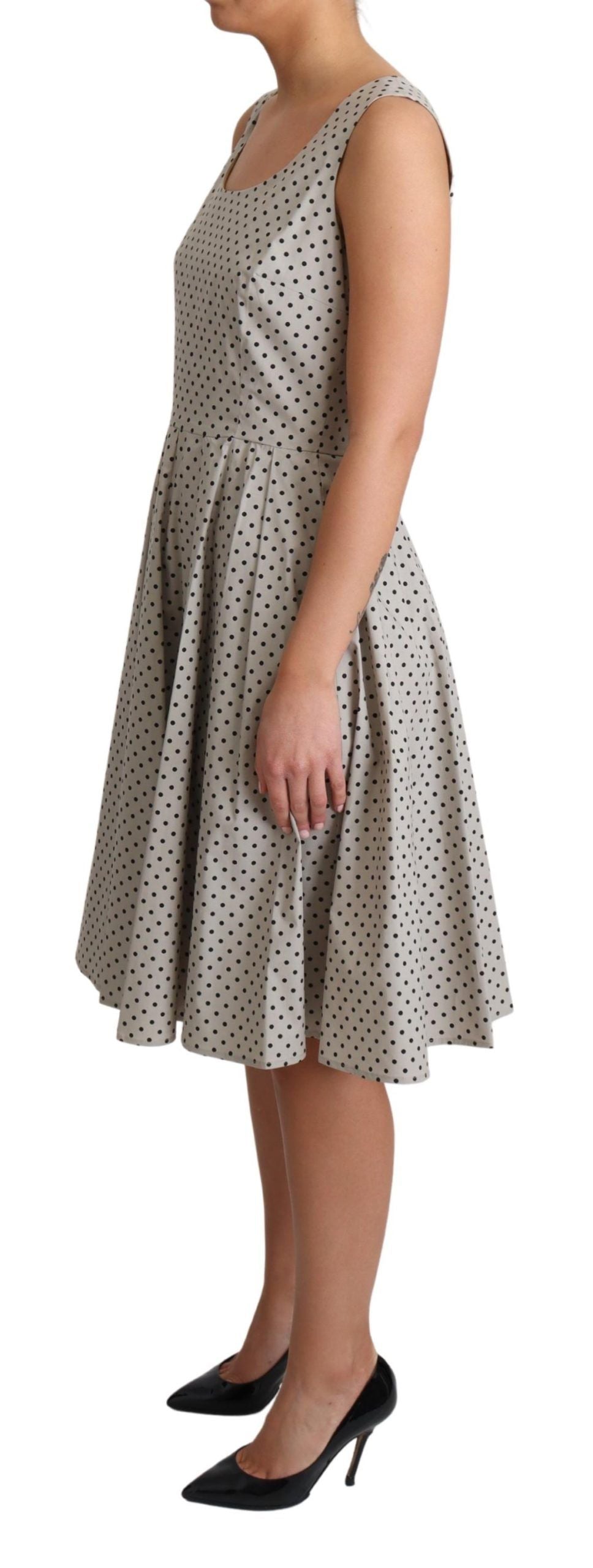 Beige polka dotted cotton A-line dress by Dolce & Gabbana, featuring a classic fit and playful pattern.