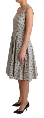 Beige polka dotted cotton A-line dress by Dolce & Gabbana, featuring a classic fit and playful pattern.