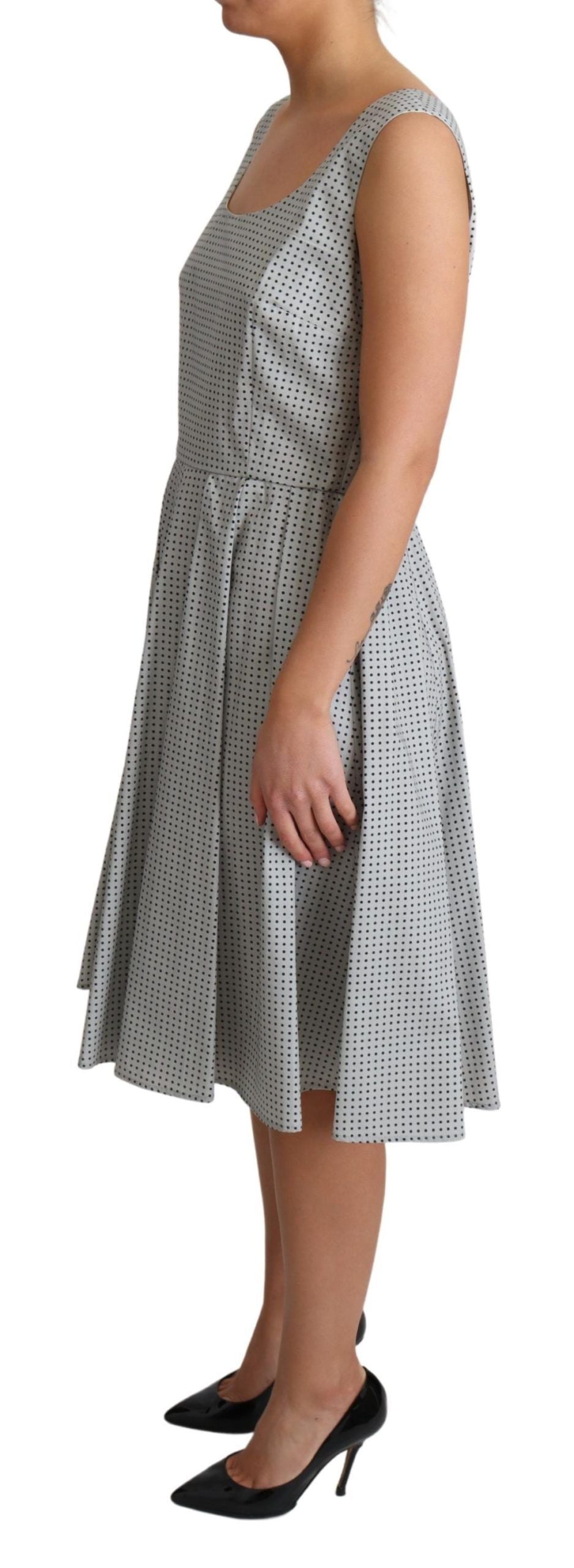 Gray polka dotted cotton A-line dress by Dolce & Gabbana displayed on a hanger with a simple background.