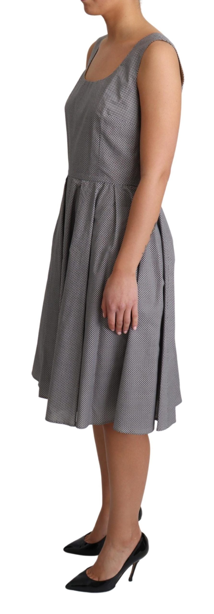 Blue beige geometric cotton A-line dress by Dolce & Gabbana displayed on a hanger with a fitted waist and flowing skirt.