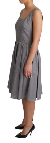 Blue beige geometric cotton A-line dress by Dolce & Gabbana displayed on a hanger with a fitted waist and flowing skirt.
