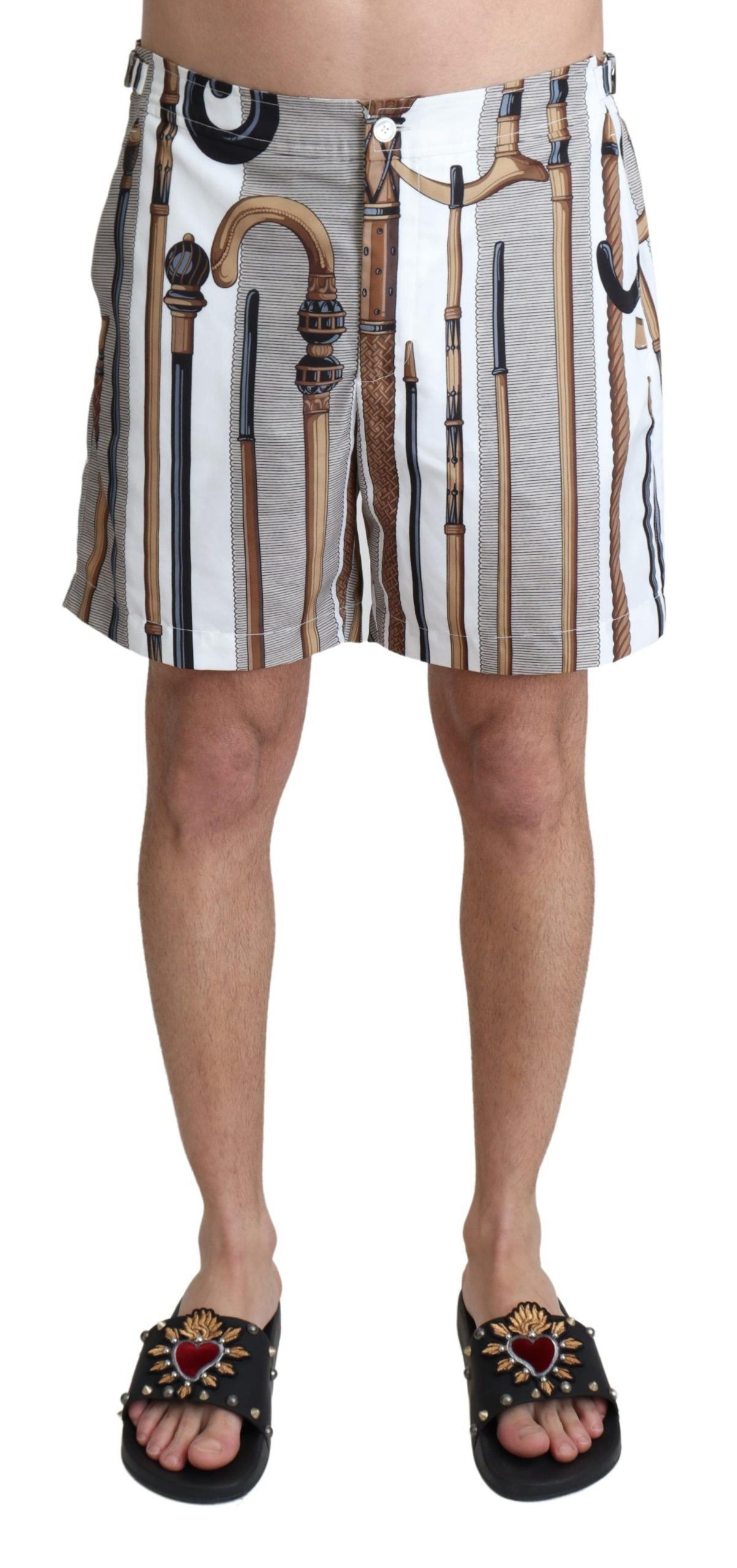White walking stick beachwear shorts by Dolce & Gabbana, showing stylish swimshorts with a relaxed fit and beach-friendly design.