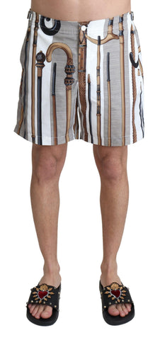 White walking stick beachwear shorts by Dolce & Gabbana, showing stylish swimshorts with a relaxed fit and beach-friendly design.