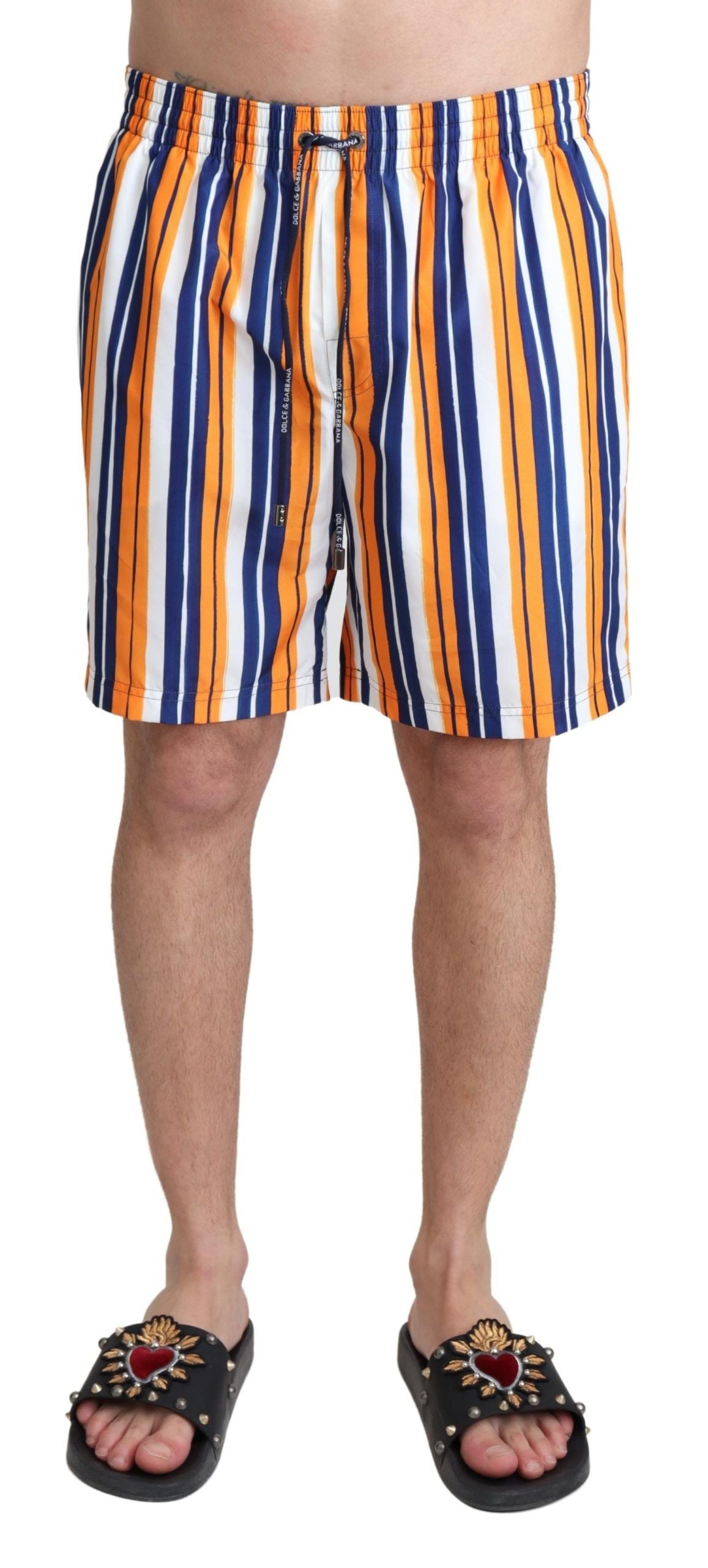Multicolor striped Dolce & Gabbana beachwear swimshorts with vibrant patterns and elastic waistband, ideal for swimming and beachwear.