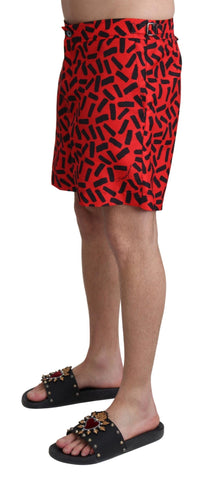 Red patterned Dolce & Gabbana beachwear shorts with a stylish swimwear design, featuring vibrant tropical print and comfortable fit.