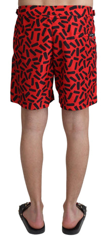 Red patterned Dolce & Gabbana beachwear shorts with a stylish swimwear design, featuring a vibrant, eye-catching pattern.