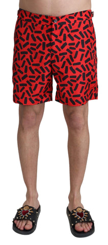 Red patterned Dolce & Gabbana beachwear shorts for men, featuring a stylish design and comfortable fit for swimming or beach outings.