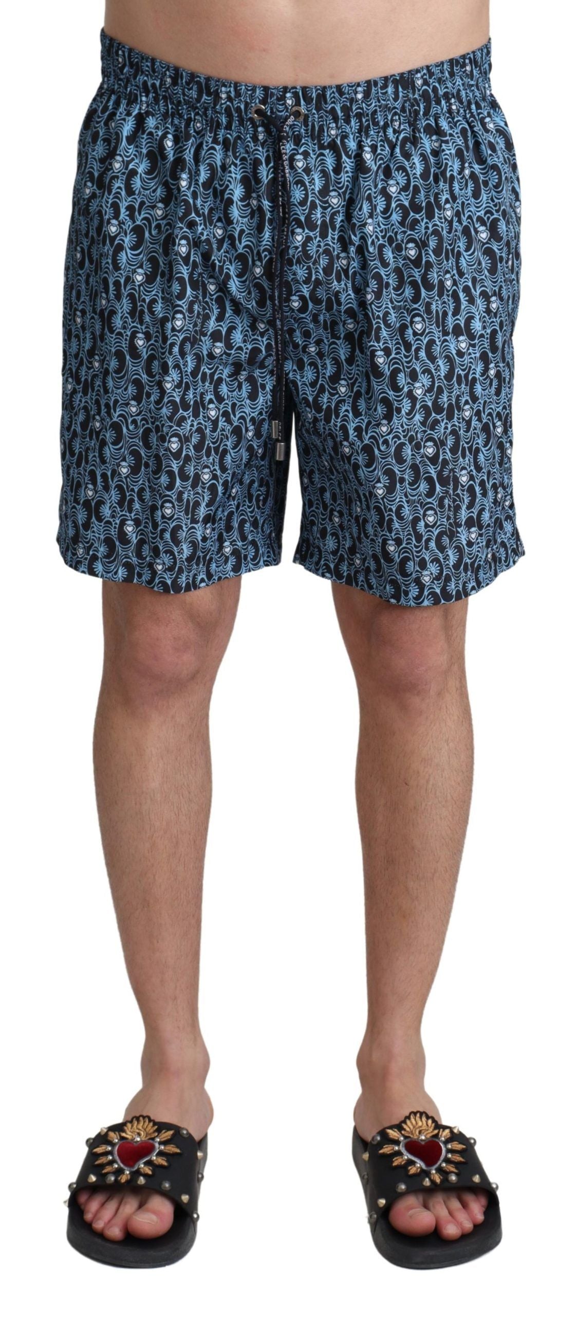Blue patterned Dolce & Gabbana beachwear shorts with a stylish print, designed for swimwear or beach outings.