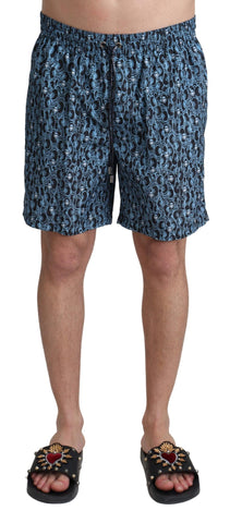 Blue patterned Dolce & Gabbana beachwear shorts with a stylish print, designed for swimwear or beach outings.