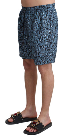 Blue patterned print Dolce & Gabbana beachwear shorts with a stylish swimwear design, perfect for summer poolside or beach days.