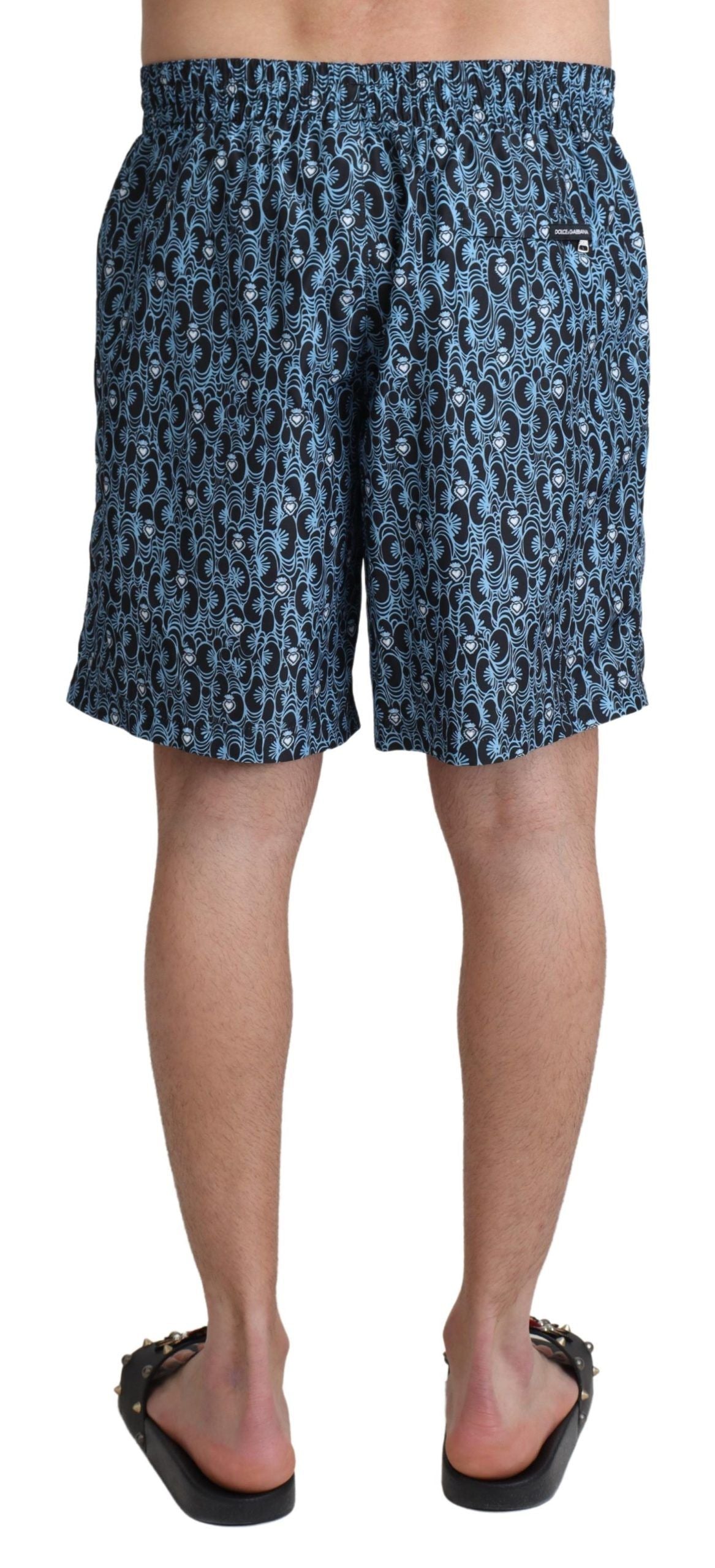 Blue patterned print Dolce & Gabbana beachwear shorts for men, featuring a stylish swimwear design and comfortable fit.