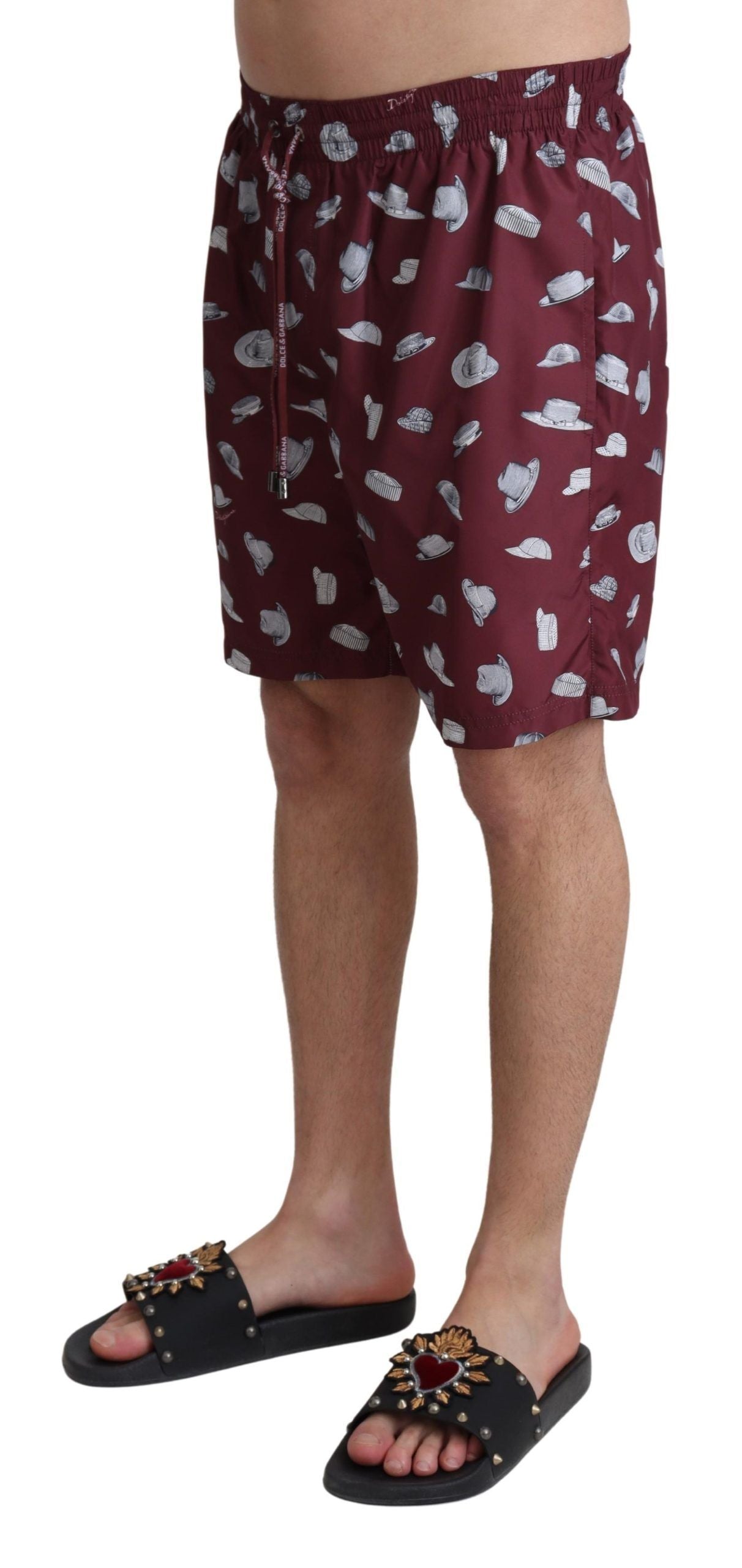 Maroon Dolce & Gabbana beachwear shorts with printed design, suitable for swimwear and beach outings.