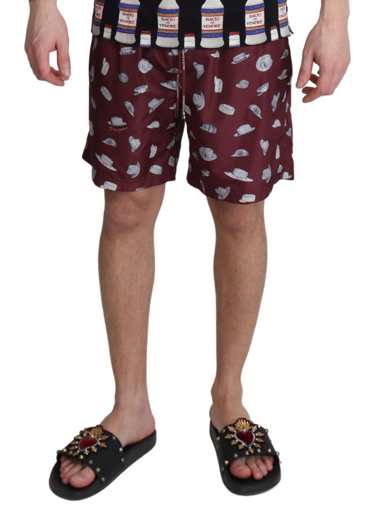 Dolce & Gabbana maroon beachwear shorts with hat print, stylish swimwear for beach and poolside lounging.
