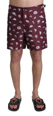 Maroon Dolce & Gabbana beachwear shorts with print design, ideal for swimwear or casual beach outings.