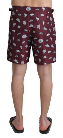 Maroon Dolce & Gabbana beachwear shorts with hat print, suitable for swimming and beach outings.