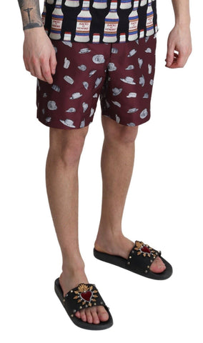 Maroon Dolce & Gabbana beachwear shorts with print design, styled for swimwear or casual beach outings.
