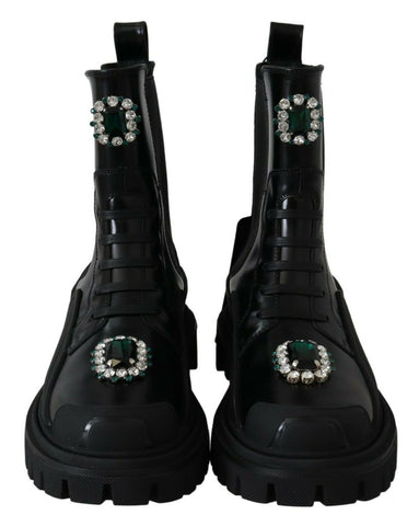Black leather crystal-embellished combat boots by Dolce & Gabbana, featuring rugged soles and decorative crystals.