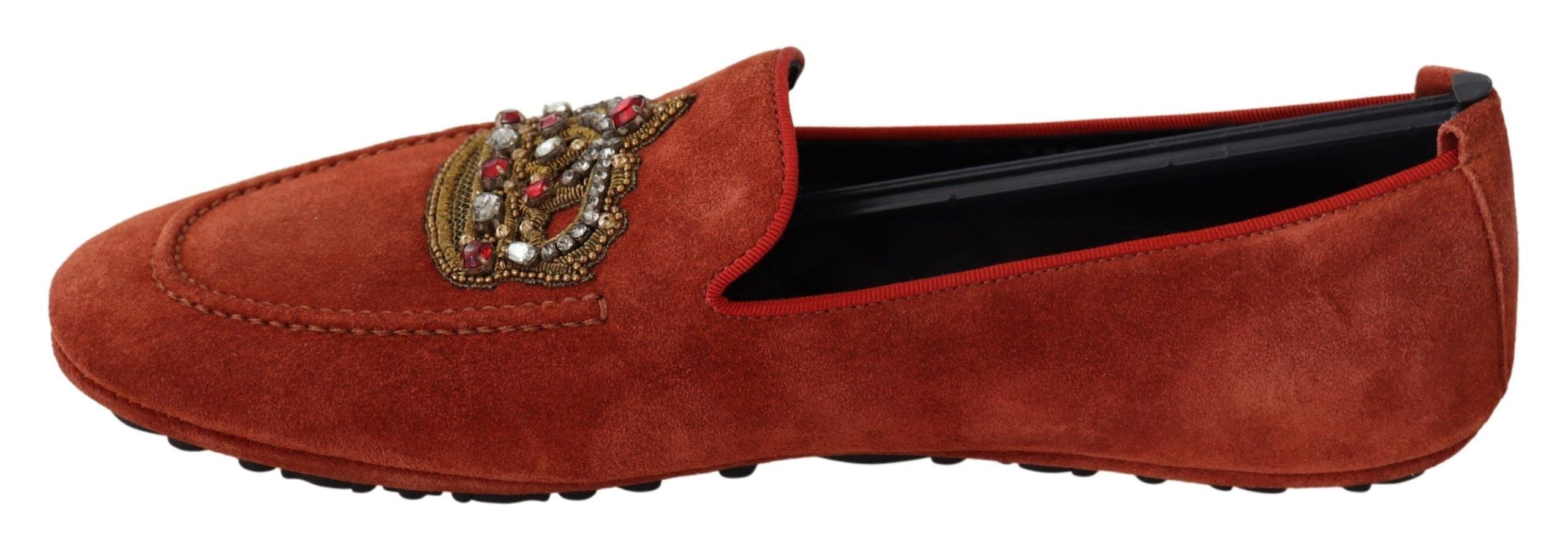 Orange leather Dolce & Gabbana crystal crown loafers with decorative embellishments and stylish design.