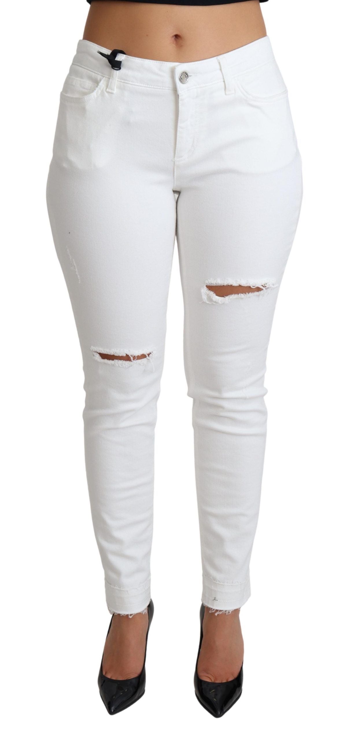 White tattered skinny denim jeans by Dolce & Gabbana, featuring distressed cotton stretch fabric and a fitted silhouette.