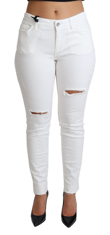 White tattered skinny denim jeans by Dolce & Gabbana, featuring distressed cotton stretch fabric and a fitted silhouette.