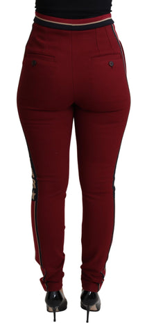 Red Dolce & Gabbana DG Star striped skinny cotton pants shown on a model, featuring bold star pattern and slim fit design.