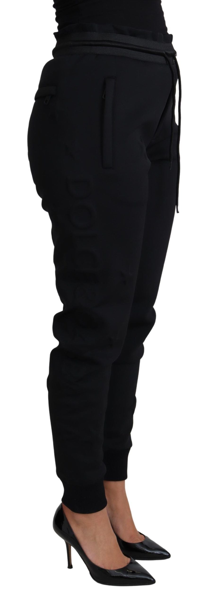 Black polyester neoprene jogger trousers by Dolce & Gabbana, showing the relaxed fit and elastic waistband.