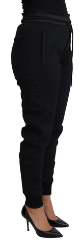 Black polyester neoprene jogger trousers by Dolce & Gabbana, showing the relaxed fit and elastic waistband.