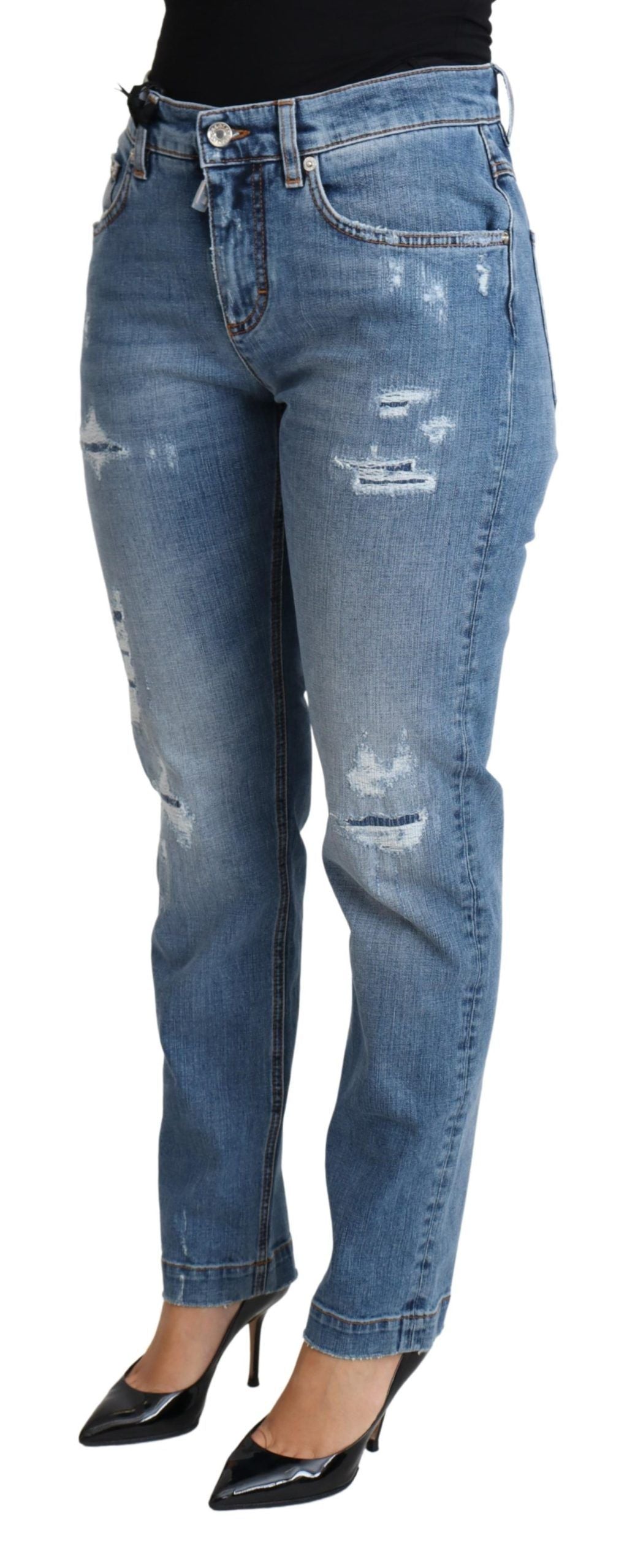 Blue tattered skinny denim jeans by Dolce & Gabbana, showing distressed cotton blend fabric and fitted silhouette.