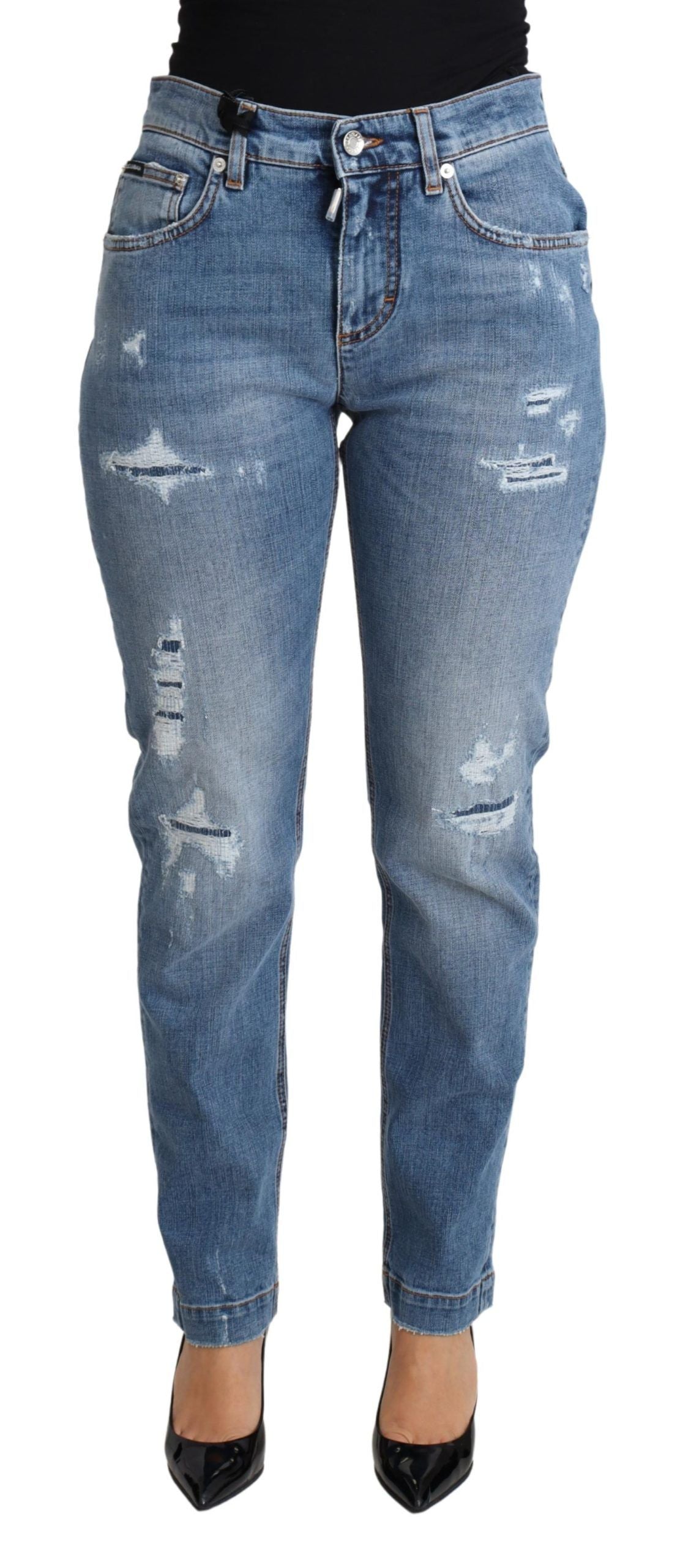 Blue tattered skinny denim jeans by Dolce & Gabbana, made from cotton blend, shown with distressed details and slim fit silhouette.