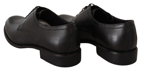 Black leather lace-up men's formal derby shoes by Dolce & Gabbana, featuring a sleek design and polished finish.