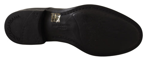 Black leather lace-up men's formal derby shoes by Dolce & Gabbana, featuring classic design and polished finish.