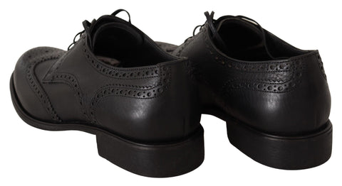 Black leather Oxford wingtip dress shoes by Dolce & Gabbana, featuring classic formal design and detailed brogue accents.