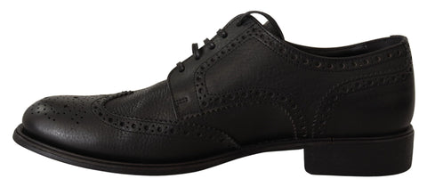 Black leather Oxford wingtip dress shoes by Dolce & Gabbana, featuring classic formal design with brogue detailing.