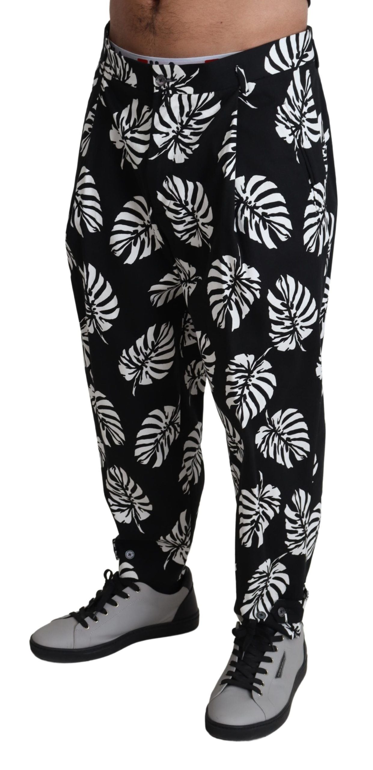 Black leaf cotton stretch trouser pants by Dolce & Gabbana, showing the tailored fit and leaf pattern fabric.