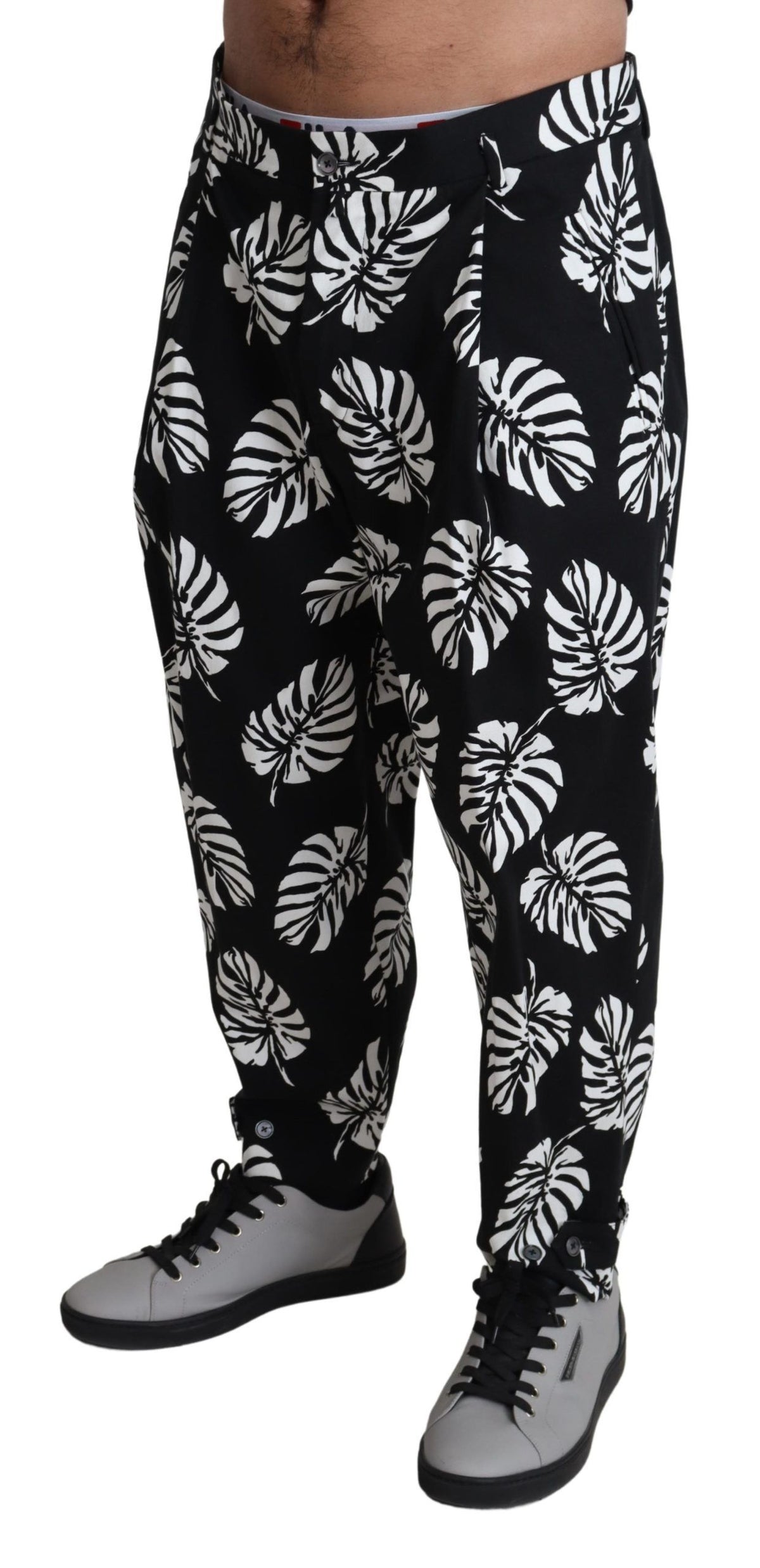 Black leaf cotton stretch trouser pants by Dolce & Gabbana, showing the tailored fit and leaf pattern fabric.