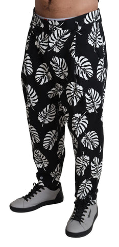Black leaf cotton stretch trouser pants by Dolce & Gabbana, showing the tailored fit and leaf pattern fabric.