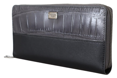 Black leather zip-around continental clutch wallet by Dolce & Gabbana with multiple card slots and a sleek, compact design.