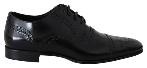 Black leather men’s Derby formal loafers by Dolce & Gabbana, featuring sleek design and classic slip-on style.
