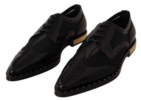 Black leather brogue wingtip shoes with sheer details by Dolce & Gabbana, showcasing classic design and intricate stitching.