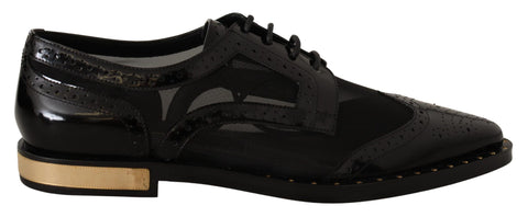 Black leather brogue wingtip shoes with sheer detailing by Dolce & Gabbana, featuring classic wingtip design and polished finish.