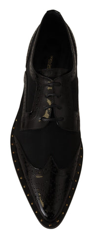 Black leather brogue wingtip shoes with sheer details by Dolce & Gabbana, featuring classic wingtip design and polished finish.