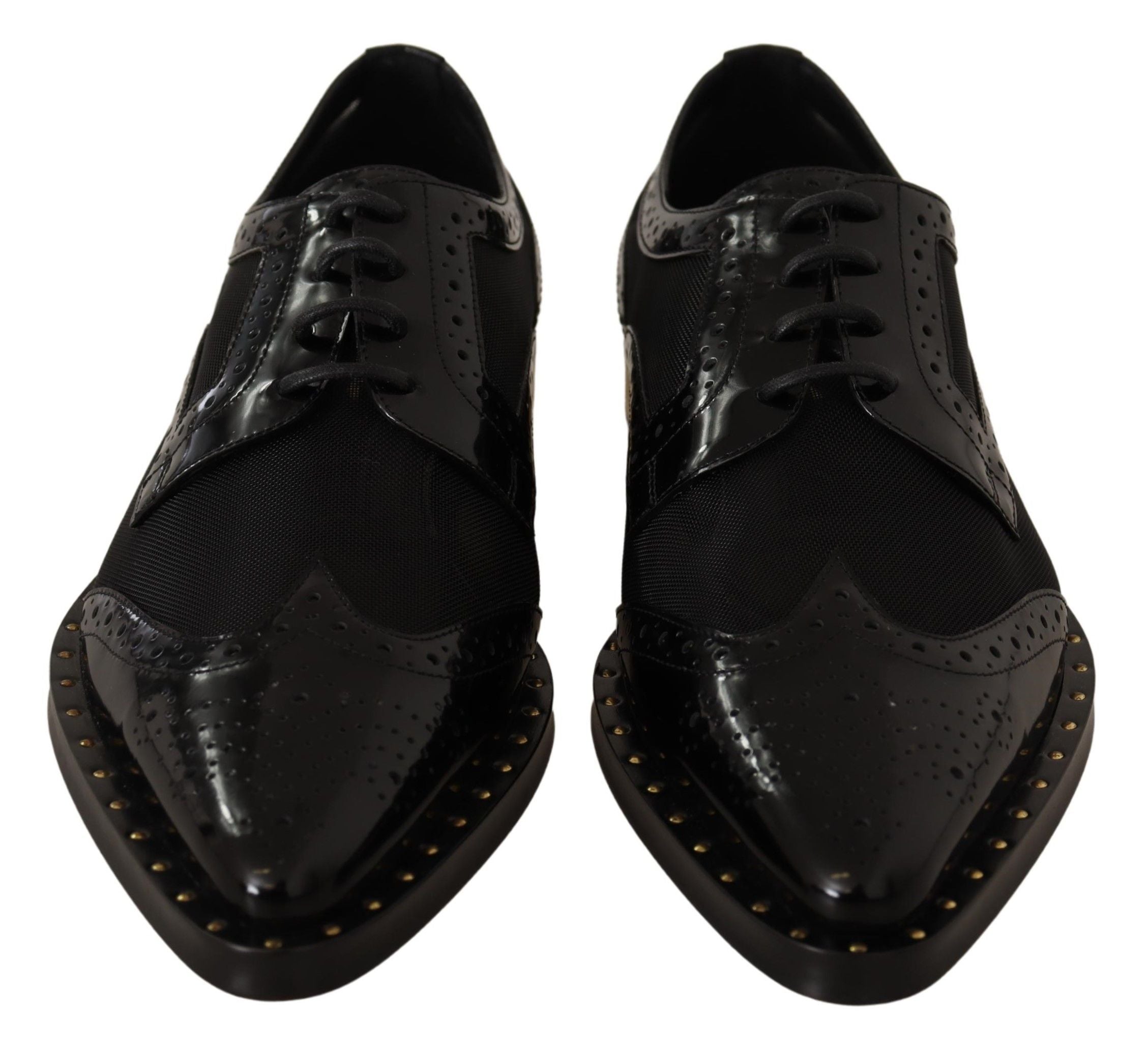 Black leather brogue wingtip shoes by Dolce & Gabbana featuring sheer panels and classic wingtip detailing.